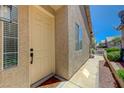 Inviting front door of home with a textured exterior and desert landscaping at 201 Crown Imperial St, Henderson, NV 89074