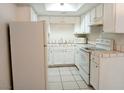 Efficient kitchen with white cabinets and tile countertops at 2471 Old Forge Ln # 105, Las Vegas, NV 89121