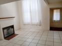 Bright living room featuring a fireplace and neutral tile flooring at 2471 Old Forge Ln # 105, Las Vegas, NV 89121