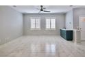 Spacious living room with marble floors, ceiling fan and natural light at 248 Crystal Rose Ct, Las Vegas, NV 89106
