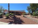 A single-story home with desert landscaping, solar panels, and a covered patio at 2965 Palma Vista Cir, Las Vegas, NV 89169