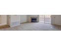 The carpeted living room offers a fireplace and sliding glass doors to the outside at 3318 N Decatur Blvd # 2103, Las Vegas, NV 89130