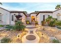 Inviting front entrance with custom pathway lighting and mature landscaping at 3540 Wisdom Ct, Las Vegas, NV 89120