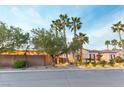 Attractive single-story home featuring lush landscaping, palm trees, and a paved street at 3540 Wisdom Ct, Las Vegas, NV 89120