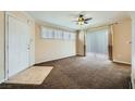Bright living room with neutral walls, carpet, fan, and sliding glass door, perfect for relaxation and entertaining at 4400 S Jones Blvd # 2007, Las Vegas, NV 89103