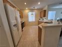 Functional kitchen features bright lighting and modern appliances, and a breakfast bar at 4814 Regalo Bello St, Las Vegas, NV 89135