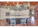 Spacious kitchen featuring custom cabinets, a large island, and stainless steel appliances at 5110 N Valadez St, Las Vegas, NV 89149