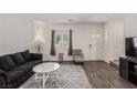 Bright living room with modern furniture, dark wood floors, and neutral walls for versatile decorating at 527 Clearsable Ave, Henderson, NV 89044