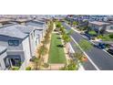 Landscaped neighborhood park featuring benches, grassy area, trees, and sidewalks at 527 Clearsable Ave, Henderson, NV 89044