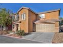Two-story home featuring a charming front entrance, two-car garage, and low-maintenance desert landscaping at 5308 Carlsbad Heights St, North Las Vegas, NV 89081