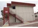 View of building exterior and access stairs with neutral paint and red trim at 5388 Swenson St # 26, Las Vegas, NV 89119