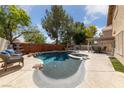 Stunning backyard features a sparkling pool and spa, complemented by a built-in grill and ample patio space at 5452 Desert Spring Rd, Las Vegas, NV 89149