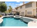 Backyard oasis with sparkling pool, spa, lounge chairs and outdoor kitchen at 5452 Desert Spring Rd, Las Vegas, NV 89149