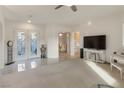Bright, open-concept living room with tile floors, recessed lighting, and a view to the formal dining room at 585 Mountain Links Dr, Henderson, NV 89012