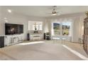 Spacious living room with large windows offering views of the lush golf course at 585 Mountain Links Dr, Henderson, NV 89012