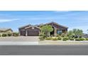 Beautiful home featuring desert landscaping, a brick driveway, and a two-car garage at 6208 W Rome Blvd, Las Vegas, NV 89131