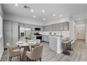 Eat-in kitchen with stainless appliances, gray cabinets, and breakfast bar at 6346 Azurelyn Ave, Las Vegas, NV 89122