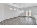 Bright living room featuring hardwood floors and sliding glass doors to the backyard at 6346 Azurelyn Ave, Las Vegas, NV 89122