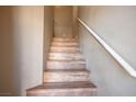 View of a wooden staircase with a white handrail at 6610 Tumbleweed Ridge Ln # 101, Henderson, NV 89011