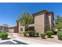 Landscaped view of a two-story home with a well-maintained lawn and inviting walkway at 6635 Caporetto Ln # 204, North Las Vegas, NV 89084
