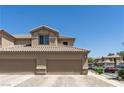 Spacious two-car garage with a well-maintained driveway and landscaped surroundings at 6635 Caporetto Ln # 204, North Las Vegas, NV 89084