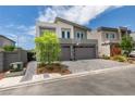 Stylish two-story home with a two-car garage, featuring a basketball hoop and landscaped front yard at 681 Stone Hammer Ave, Las Vegas, NV 89183