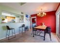 An open dining area with a bar and chandelier creates a seamless entertaining space at 7255 W Sunset Rd # 2030, Las Vegas, NV 89113
