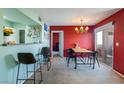 Dining area with bar access, a chandelier, and a sliding glass door for outdoor access at 7255 W Sunset Rd # 2030, Las Vegas, NV 89113