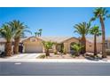 Beautiful single-story home with well-maintained landscaping and several mature palm trees at 7540 Flowing Stream Dr, Las Vegas, NV 89131