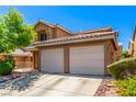Charming two-story home featuring a two-car garage, xeriscape landscaping, and a classic tile roof at 8041 Astrology Ct # 201, Las Vegas, NV 89128