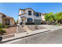 Attractive two-story home showcasing a well-maintained yard, rock garden and attached two-car garage at 8061 Palace Estate Ave, Las Vegas, NV 89117