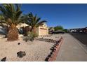 Exterior view of home showcasing the desert landscaping and well-maintained lawn at 851 Brahma Ln, Henderson, NV 89002