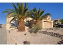 Charming single-story home with desert landscaping, mature palm trees, and a quaint front yard at 851 Brahma Ln, Henderson, NV 89002