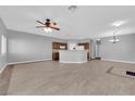 Bright and spacious living room with tile floors, a ceiling fan, and access to the kitchen at 8658 Tom Noon Ave # 103, Las Vegas, NV 89178