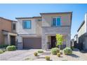 Attractive two-story home with stone veneer, a two-car garage, and a brick paver driveway at 9256 Alden Pointe Ct, Las Vegas, NV 89143