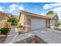 Single-story home featuring a spacious driveway and attached two-car garage at 9412 Mount Cherie Ave # 102, Las Vegas, NV 89129