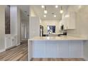 Bright kitchen with quartz countertops, white cabinets, and stainless steel appliances at 9412 Mount Cherie Ave # 102, Las Vegas, NV 89129