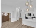 Open concept living and kitchen area featuring a large island, white cabinets, and modern lighting at 9412 Mount Cherie Ave # 102, Las Vegas, NV 89129