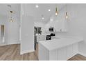 Modern white kitchen with stainless steel appliances and beautiful pendant lighting at 9412 Mount Cherie Ave # 102, Las Vegas, NV 89129
