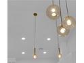Statement lighting fixture with clear glass shades and brass accents above the Kitchen at 9412 Mount Cherie Ave # 102, Las Vegas, NV 89129