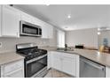 Bright kitchen with stainless steel appliances, light cabinets, and easy access to the dining area at 9957 Fine Fern St, Las Vegas, NV 89183
