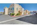 Inviting townhouse complex with attached garages and manicured grounds at 9975 Peace Way # 1024, Las Vegas, NV 89147