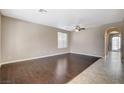 Spacious living room featuring hardwood floors, neutral walls, and modern ceiling fan at 1011 Pecos River Ave, Henderson, NV 89002
