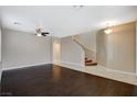 Inviting living room showcasing hardwood floors, a staircase, and an open floor plan at 1011 Pecos River Ave, Henderson, NV 89002