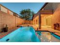 Relaxing outdoor pool and spa area with a covered patio for enjoying the backyard oasis at 1011 Pecos River Ave, Henderson, NV 89002