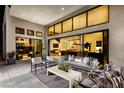 Stylish outdoor patio with modern furnishings and seamless access to the home's interior living spaces at 10848 Vista Altura Ave, Las Vegas, NV 89135