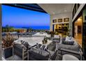 Elegant covered patio with comfortable seating, mountain views, and seamless indoor-outdoor living at 10848 Vista Altura Ave, Las Vegas, NV 89135