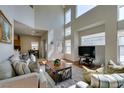 Bright living room with high ceilings and large windows offering natural light at 10952 Porto Foxi St, Las Vegas, NV 89141
