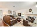 Inviting living room with traditional furnishings, a stone fireplace, and warm, neutral tones at 1104 Pinto Rock Ln # 101, Las Vegas, NV 89128