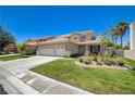 Beautiful home with a well-manicured lawn and a large driveway at 1316 Borderwood Ln, North Las Vegas, NV 89031